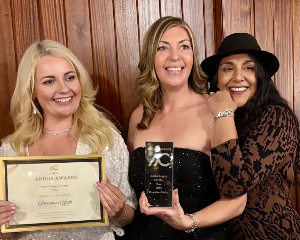 Providers Unite team members Victoria Buyer, Nicky Kaur Nagi and Kat holding the Legacy Award at the 2025 Andor Awards.
