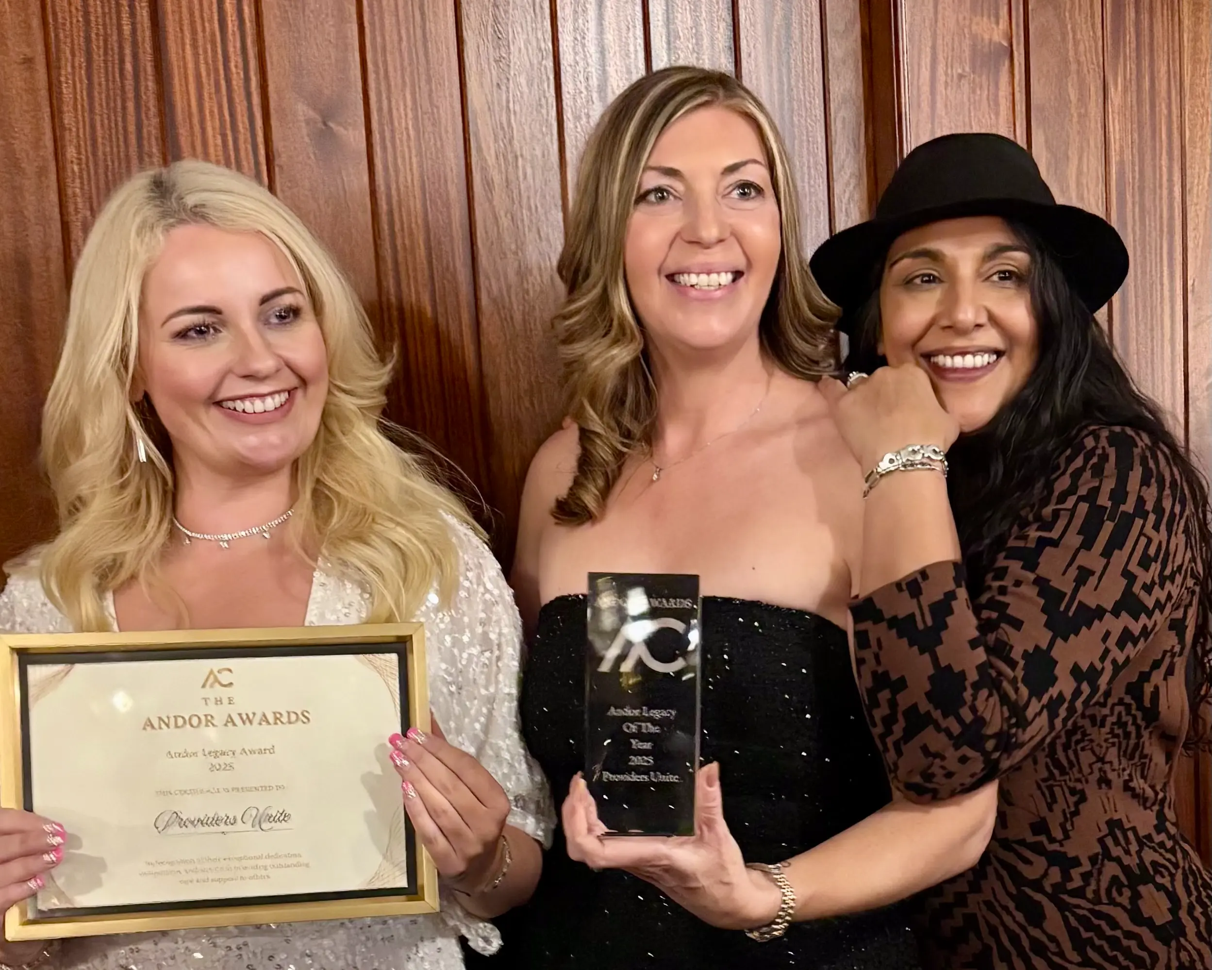 Providers Unite team members Victoria Buyer, Nicky Kaur Nagi and Kat holding the Legacy Award at the 2025 Andor Awards.