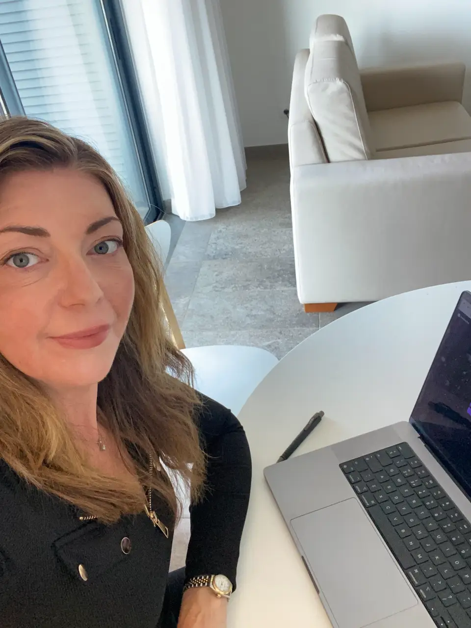 Consultant working at a laptop in a bright office